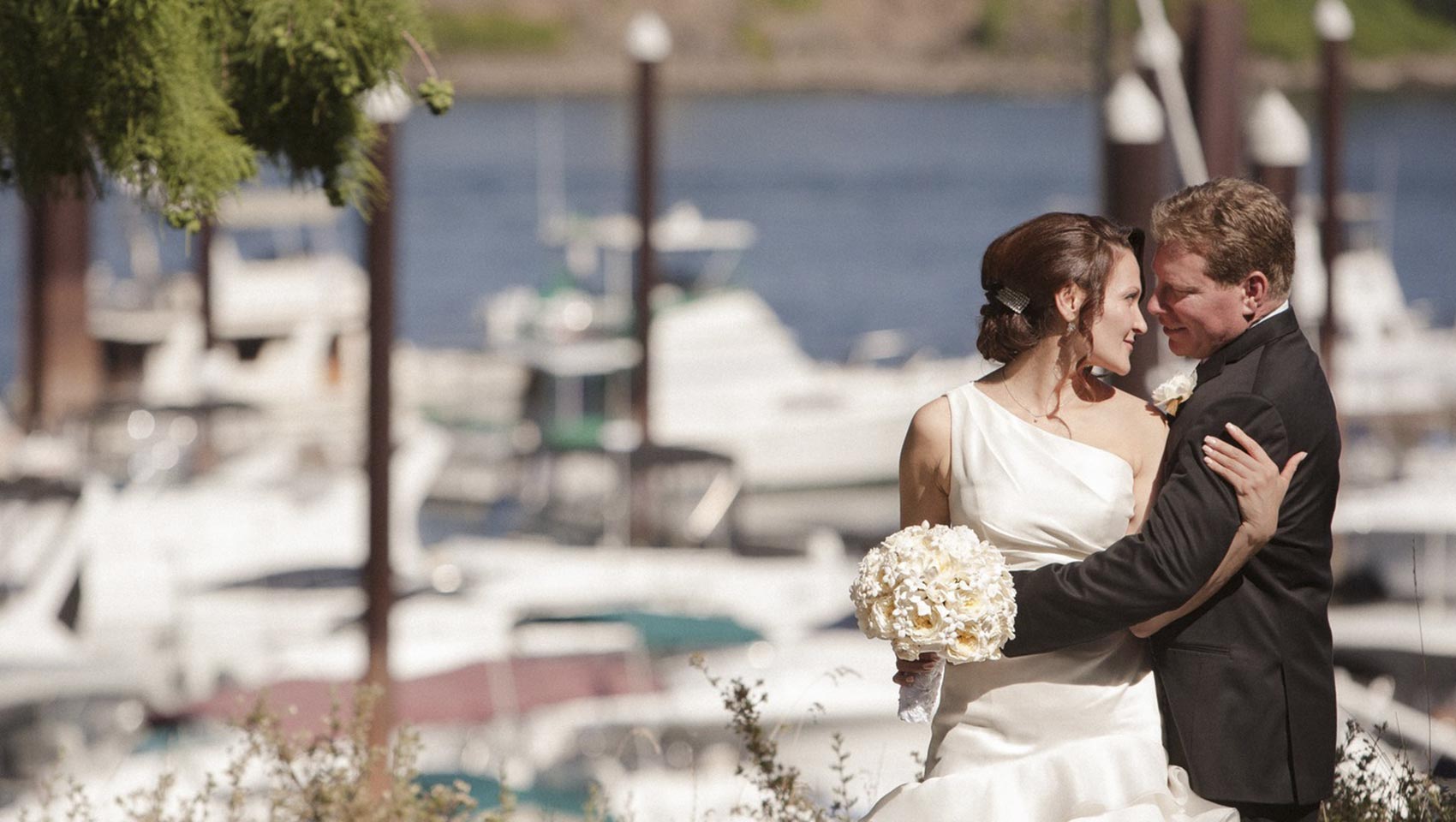 wedding couple embracing on downtown Portland waterfront