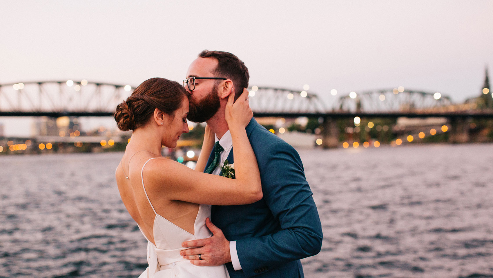 bride and groom having romantic private moment infront of Portland waterfront