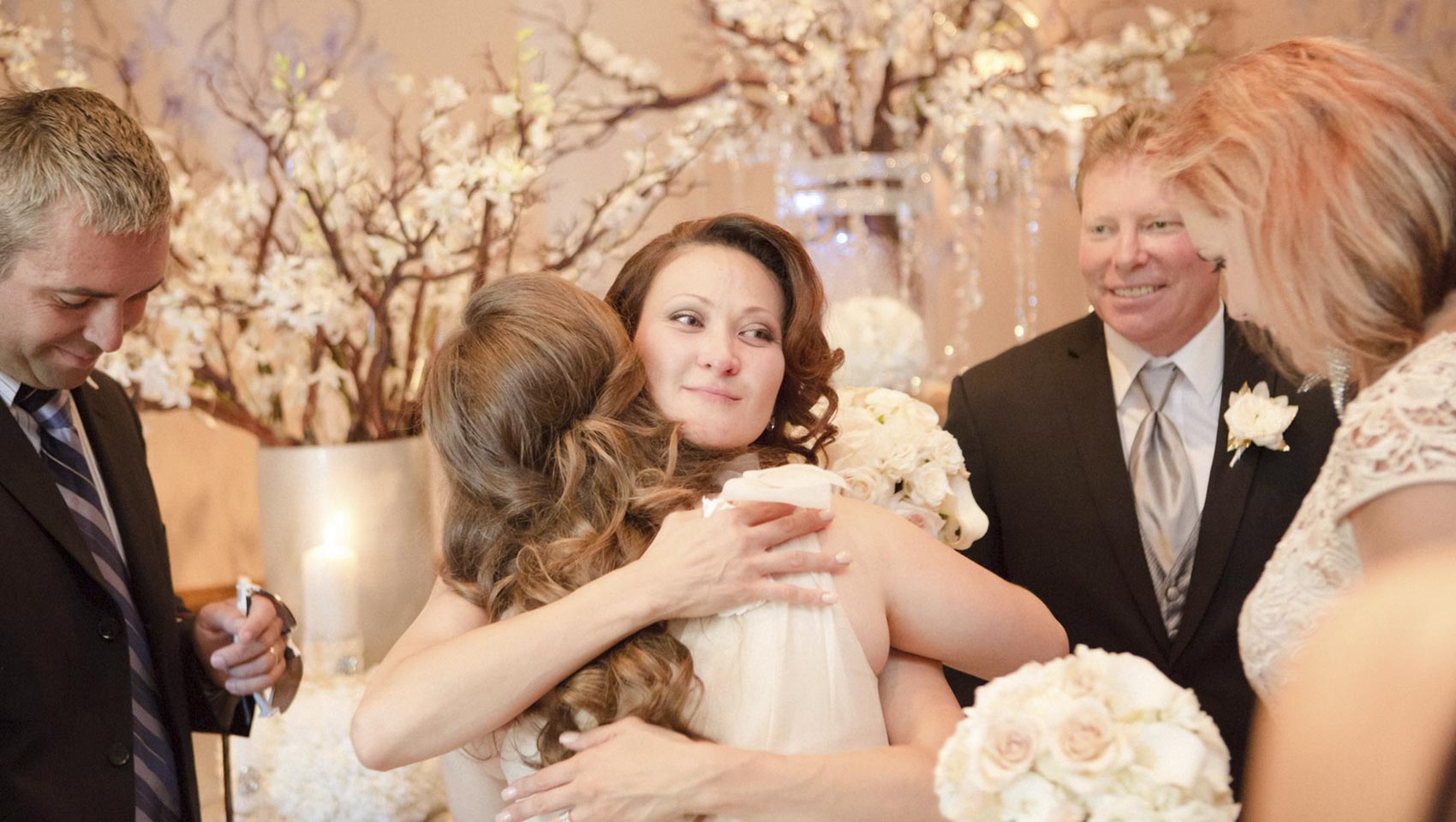 bride hugging bridesmaids