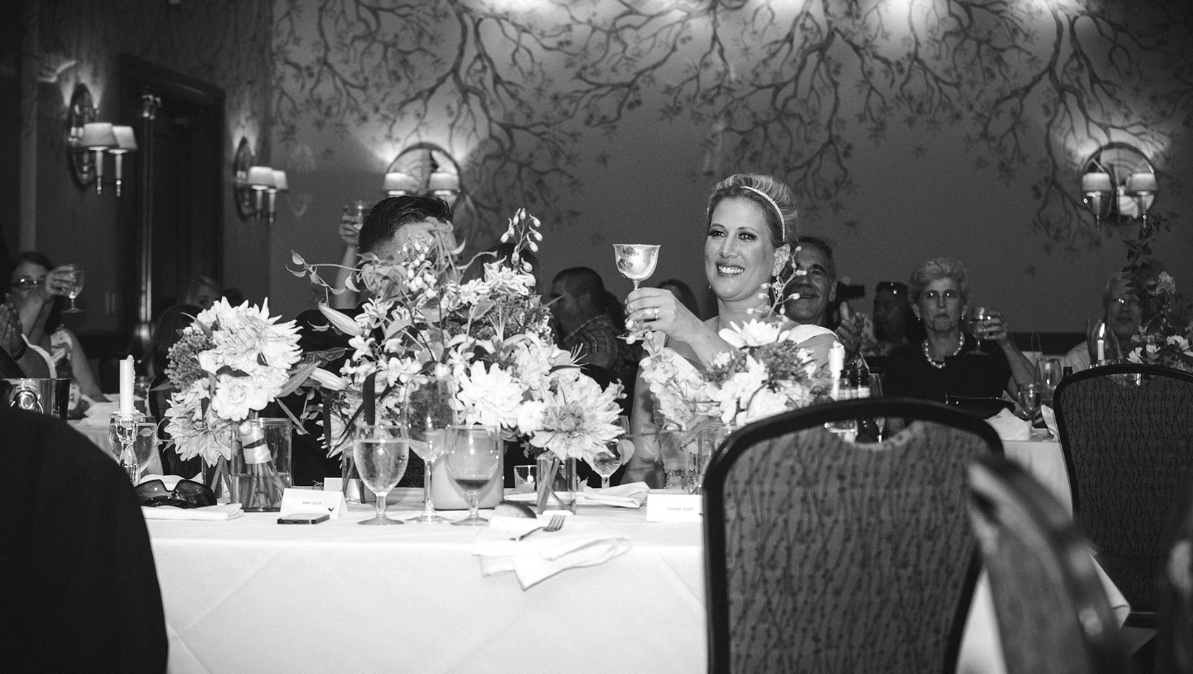 bride toasting glass at wedding reception