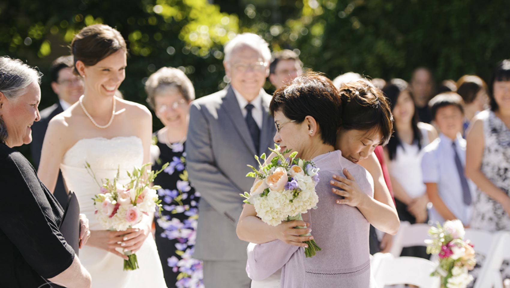 Bride hugs mom at hotel wedding venue