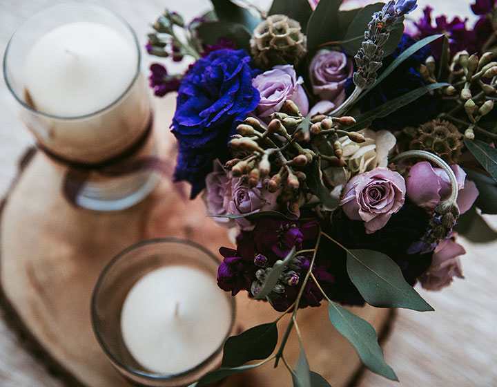 Wedding centerpiece with candles and a flower arrangement