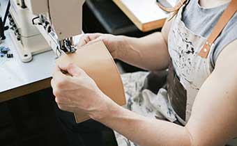 woman sewing leather