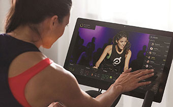 Woman on Peloton bike