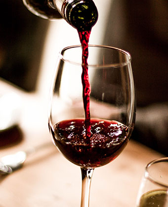 pouring a glass of red wine